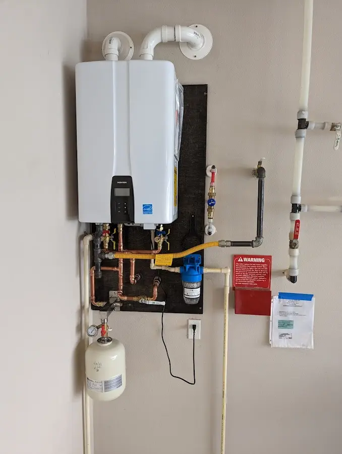 Professional plumber installing copper piping in a Wildomar home